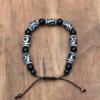 Pulsera h.u.e.s.o de Yak con cuentas de ónix y símbolo de protección Tibetano (Ojo Dzi).