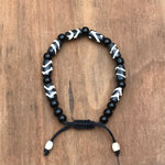 Pulsera h.u.e.s.o de Yak tipo cebra con cuentas de ónix (protección).